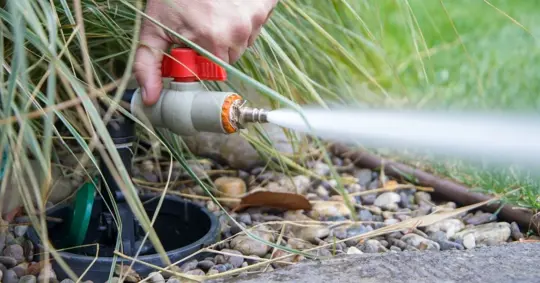 water valve being turned on to release a stream of water